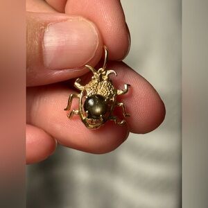 10k bug with black star sapphire cab charm